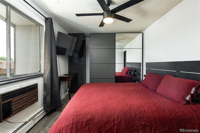 2700 S Holly St Unit 202, Denver, CO 80222 - carpeted bedroom with baseboard heating, a textured ceiling, and a ceiling fan