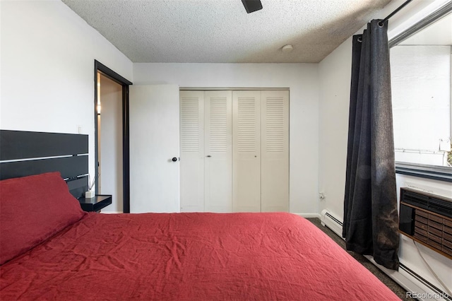 2700 S Holly St Unit 202, Denver, CO 80222 - carpeted bedroom with a closet, a textured ceiling, a baseboard heating unit, a baseboard radiator, and ceiling fan