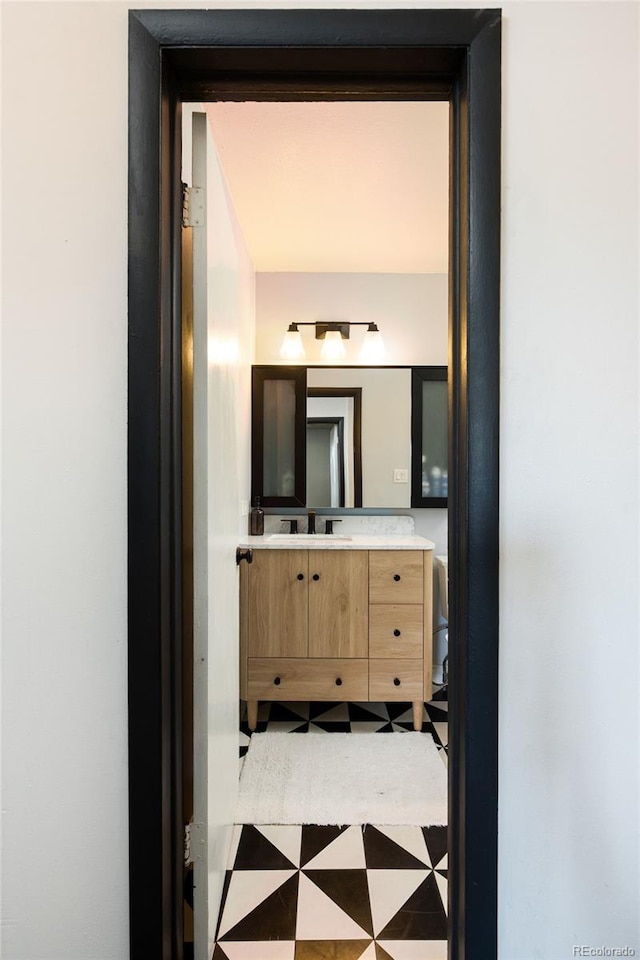 2700 S Holly St Unit 202, Denver, CO 80222 - bathroom featuring vanity and tile patterned floors