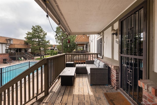 2700 S Holly St Unit 202, Denver, CO 80222 - wooden terrace featuring outdoor lounge area and a community pool