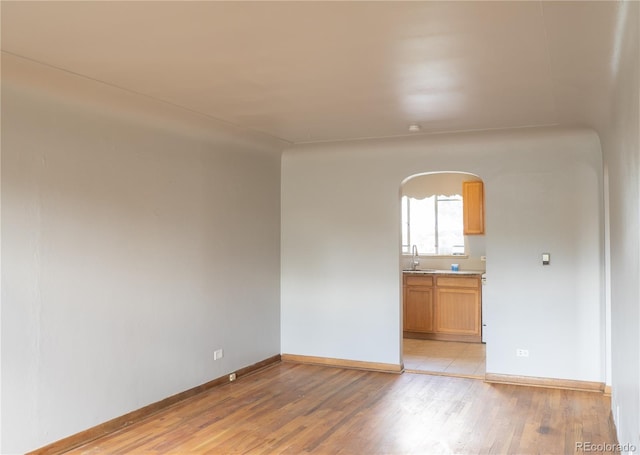 3820-3830 Pierce St, Wheat Ridge, CO 80033 - empty room with arched walkways and light wood-type flooring