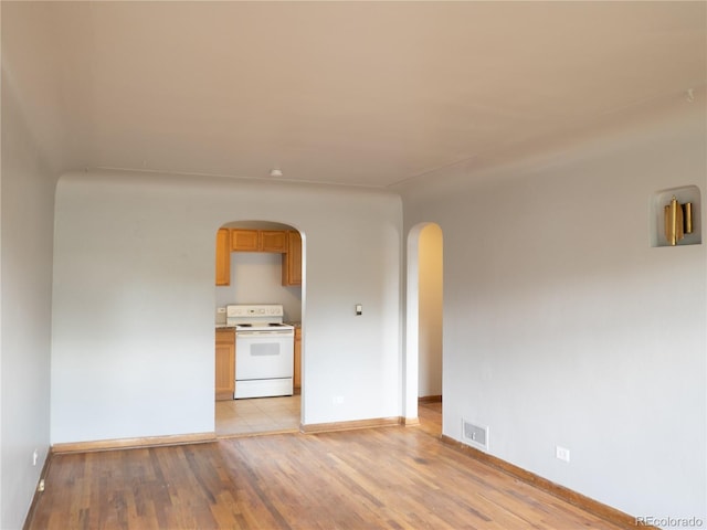 3820-3830 Pierce St, Wheat Ridge, CO 80033 - spare room with arched walkways and light wood-type flooring