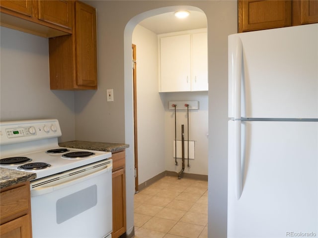 3820-3830 Pierce St, Wheat Ridge, CO 80033 - kitchen with white appliances, arched walkways, dark countertops, and brown cabinets