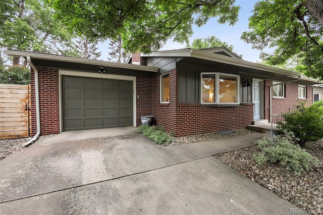632 Wyoming St, Golden, CO 80403 - ranch-style house featuring driveway, brick siding, a garage, and a chimney