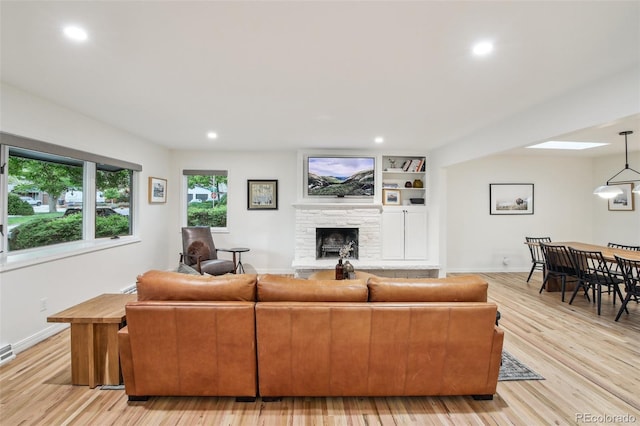 632 Wyoming St, Golden, CO 80403 - living area featuring a stone fireplace, baseboards, light wood-style flooring, and recessed lighting
