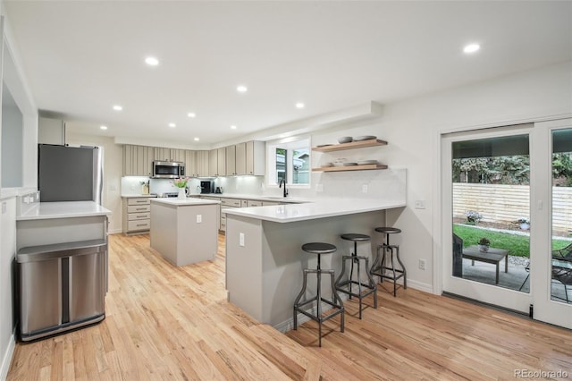 632 Wyoming St, Golden, CO 80403 - kitchen featuring appliances with stainless steel finishes, a sink, light wood-style floors, a peninsula, and recessed lighting