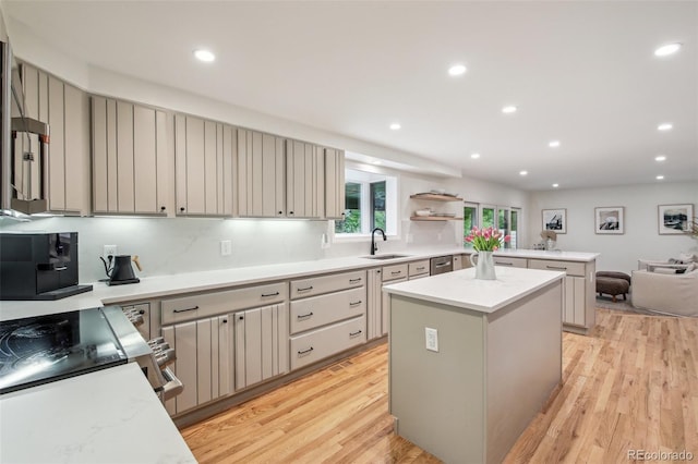 632 Wyoming St, Golden, CO 80403 - kitchen featuring light wood-style floors, a peninsula, recessed lighting, a center island, and light countertops