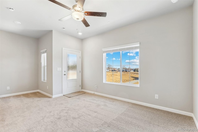 interior space with light carpet and ceiling fan