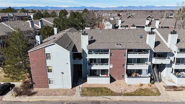 drone / aerial view featuring a mountain view and a residential view