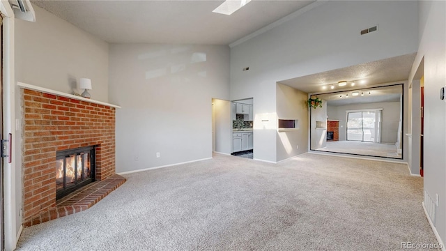 unfurnished living room featuring visible vents, a brick fireplace, baseboards, and carpet floors