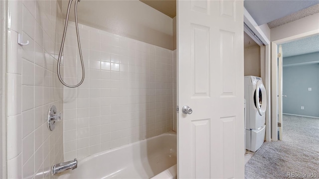 bathroom with washer / dryer and shower / washtub combination