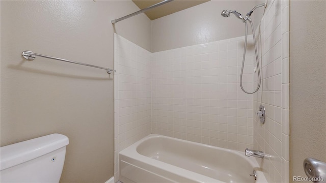 bathroom with toilet and bathtub / shower combination