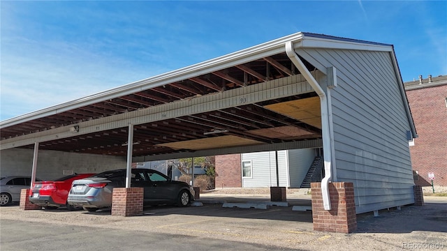 covered parking lot featuring stairway