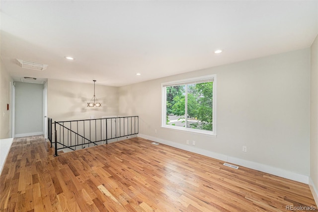 15908 E Flora Pl, Aurora, CO 80013 - empty room featuring wood finished floors, a chandelier, and recessed lighting