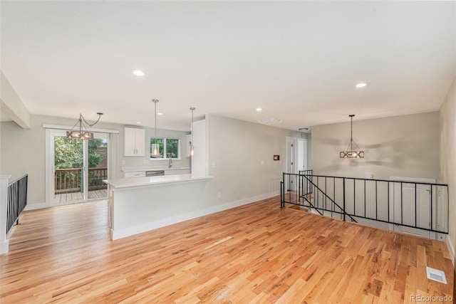 15908 E Flora Pl, Aurora, CO 80013 - unfurnished living room featuring light wood-style floors, recessed lighting, and a chandelier