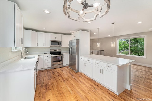 15908 E Flora Pl, Aurora, CO 80013 - kitchen featuring appliances with stainless steel finishes, light wood-style floors, white cabinets, and recessed lighting