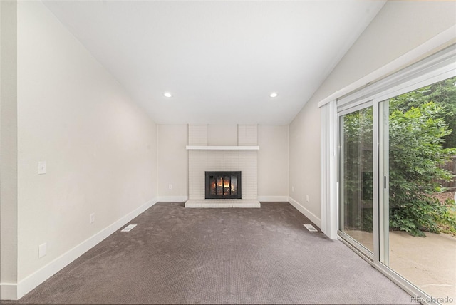 15908 E Flora Pl, Aurora, CO 80013 - unfurnished living room featuring vaulted ceiling, a fireplace, carpet flooring, and recessed lighting
