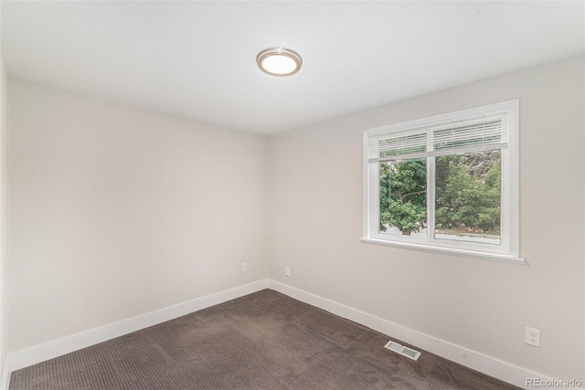 15908 E Flora Pl, Aurora, CO 80013 - spare room with baseboards and dark colored carpet