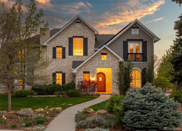 295 Jersey St, Denver, CO 80220 - view of front facade with a chimney, stone siding, and a front lawn