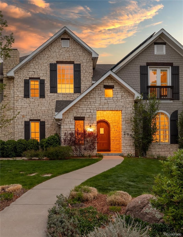 295 Jersey St, Denver, CO 80220 - view of front of property with a lawn, a balcony, and stone siding
