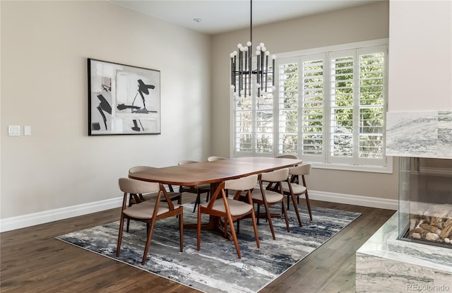 295 Jersey St, Denver, CO 80220 - dining room with baseboards, an inviting chandelier, a healthy amount of sunlight, and wood finished floors