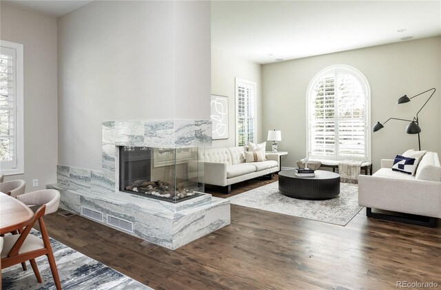 295 Jersey St, Denver, CO 80220 - living area with visible vents, wood finished floors, and a fireplace