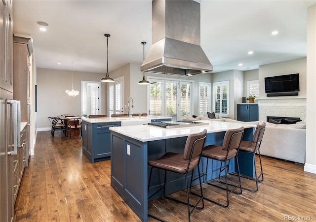 295 Jersey St, Denver, CO 80220 - kitchen featuring a sink, stainless steel gas cooktop, a large island with sink, island exhaust hood, and dark wood-style floors