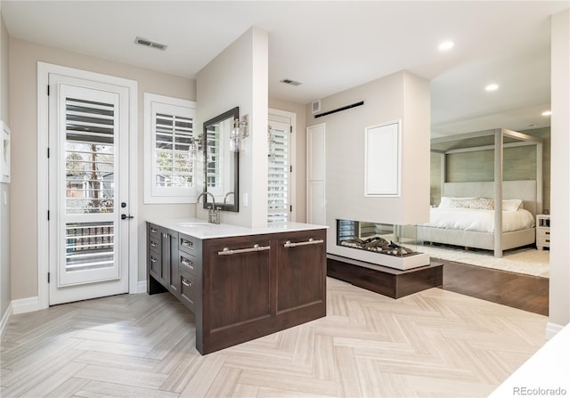 295 Jersey St, Denver, CO 80220 - ensuite bathroom featuring connected bathroom, recessed lighting, visible vents, and vanity