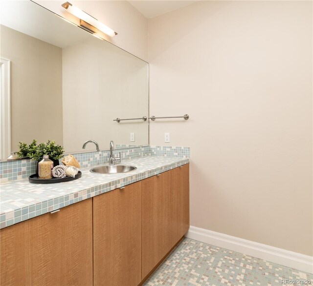 295 Jersey St, Denver, CO 80220 - bathroom with backsplash, baseboards, and vanity
