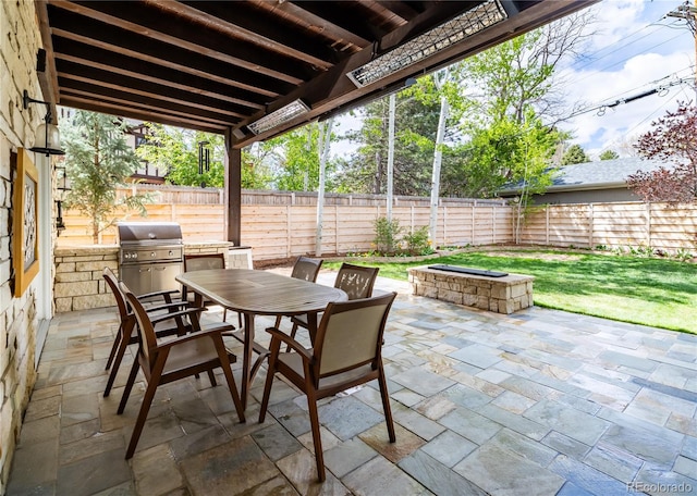 295 Jersey St, Denver, CO 80220 - view of patio / terrace with a fenced backyard, outdoor dining space, a fire pit, and a grill