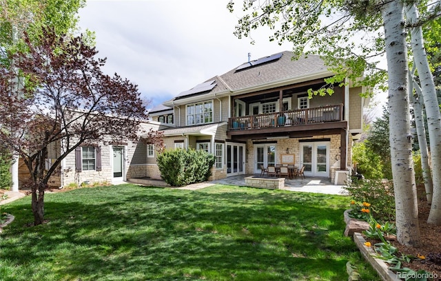 295 Jersey St, Denver, CO 80220 - back of house with a balcony, french doors, a patio area, a lawn, and solar panels
