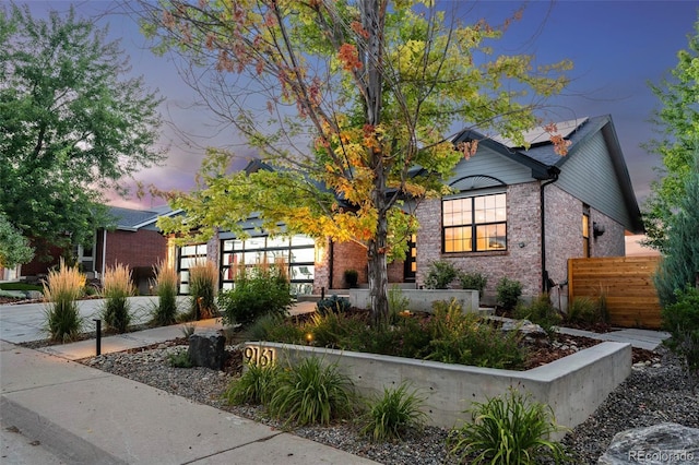 9161 W Lake Dr, Littleton, CO 80123 - view of front facade featuring brick siding and solar panels