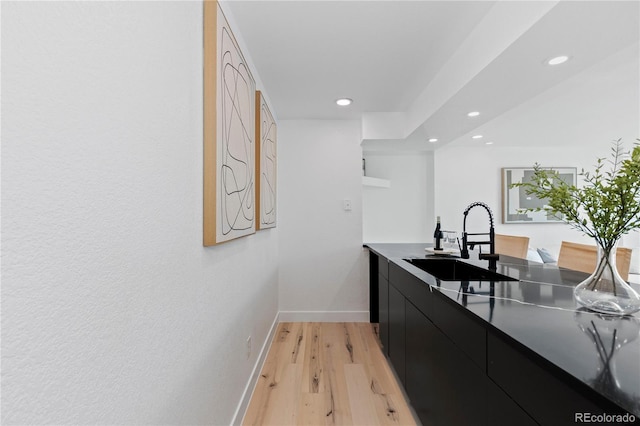 9161 W Lake Dr, Littleton, CO 80123 - kitchen with dark cabinetry, recessed lighting, light wood-type flooring, modern cabinets, and dark countertops