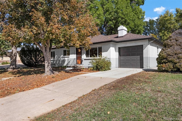 view of front of property featuring a porch, a front yard, and a garage