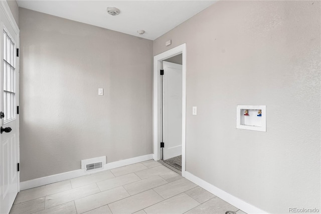 clothes washing area with visible vents, baseboards, hookup for a washing machine, and laundry area