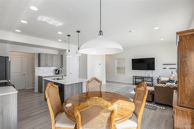 dining area featuring sink and light hardwood / wood-style floors