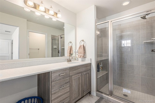 bathroom featuring vanity and a shower with shower door