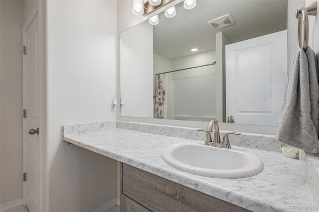 bathroom with vanity and curtained shower