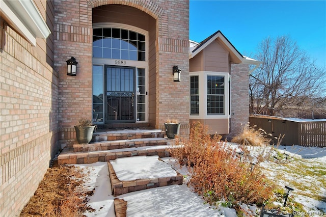 view of snow covered property entrance