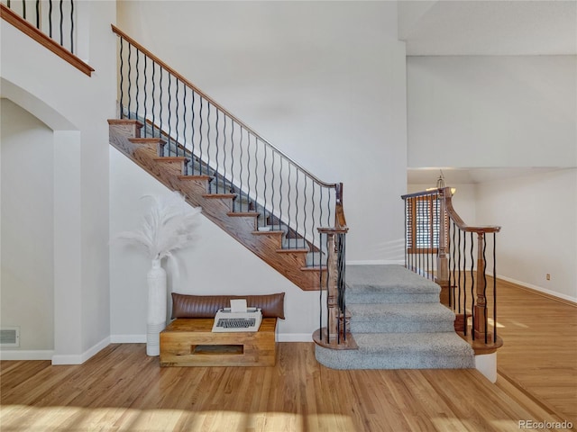 stairway featuring wood-type flooring