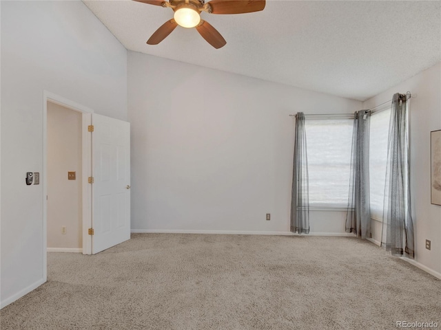 spare room featuring a textured ceiling, ceiling fan, light colored carpet, and lofted ceiling