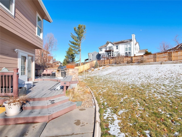 yard covered in snow featuring a wooden deck