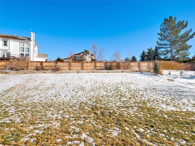 view of yard layered in snow