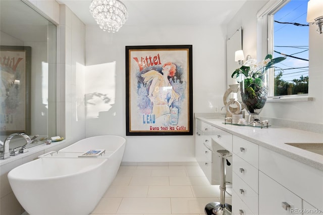 full bath with tile patterned floors, a freestanding tub, a notable chandelier, a shower stall, and vanity