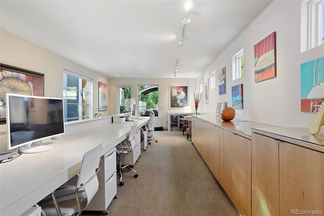 office featuring track lighting and light colored carpet