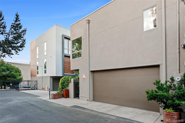 view of front of house with stucco siding and a garage