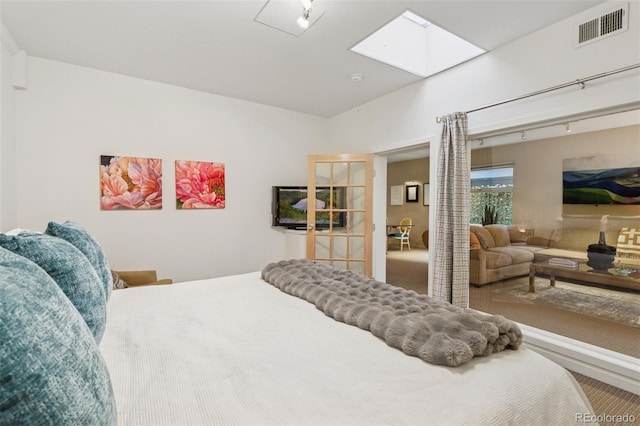 bedroom with visible vents and a skylight