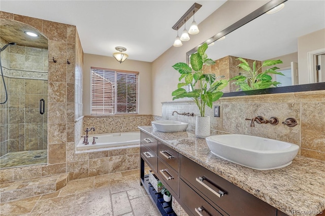 bathroom featuring stone tile flooring, a stall shower, backsplash, and a sink