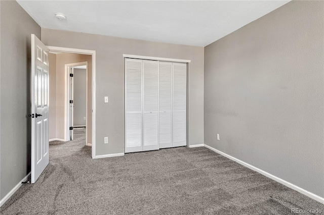 unfurnished bedroom featuring a closet, carpet flooring, and baseboards