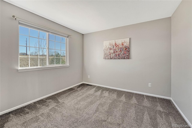 carpeted empty room with baseboards